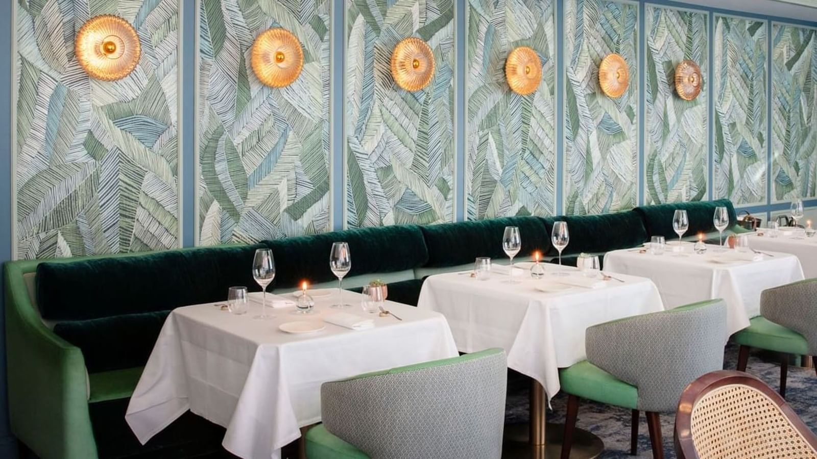 Tom Brown at The Capital dining tables with green velvet seating at The Capital Hotel, Apartments and Townhouse 