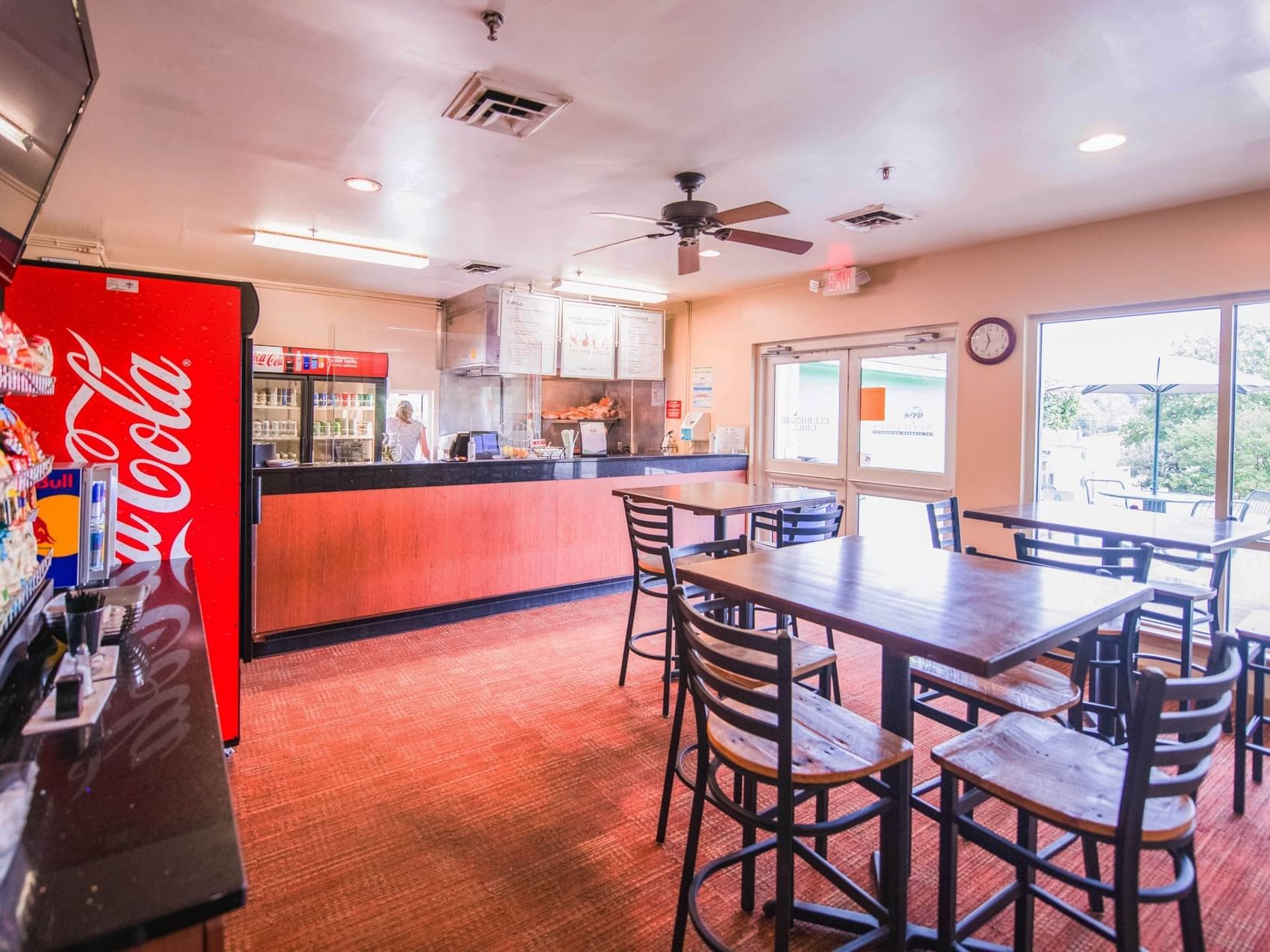 dining area with tables and chairs, counter, tv, and snacks