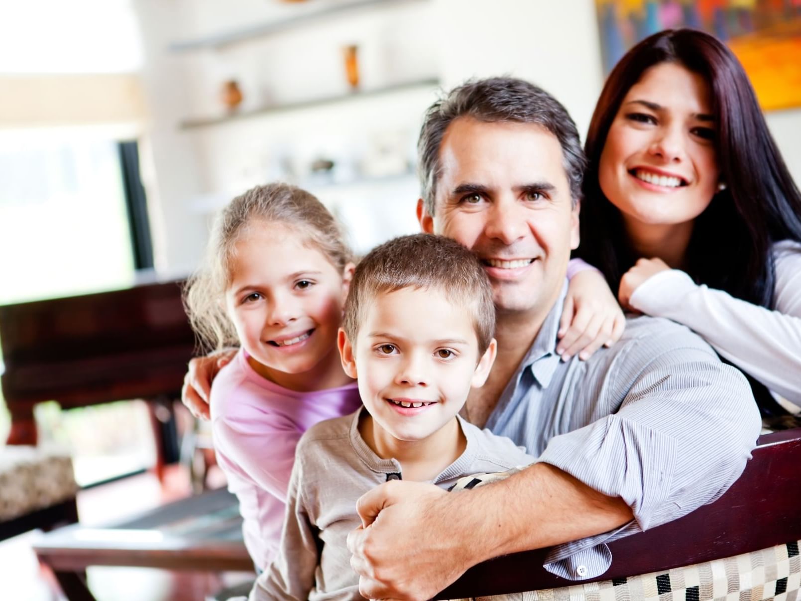 Family posing for a picture with smiles at City Seasons Hotel