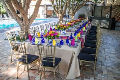 Long table arranged by the pool in Pool Area at Araiza Mexicali