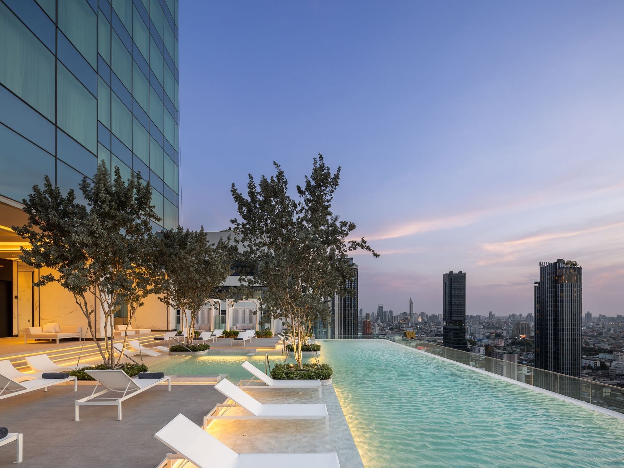 Outdoor swimming pool with sun loungers at Eastin Grand Hotel Phayathai

