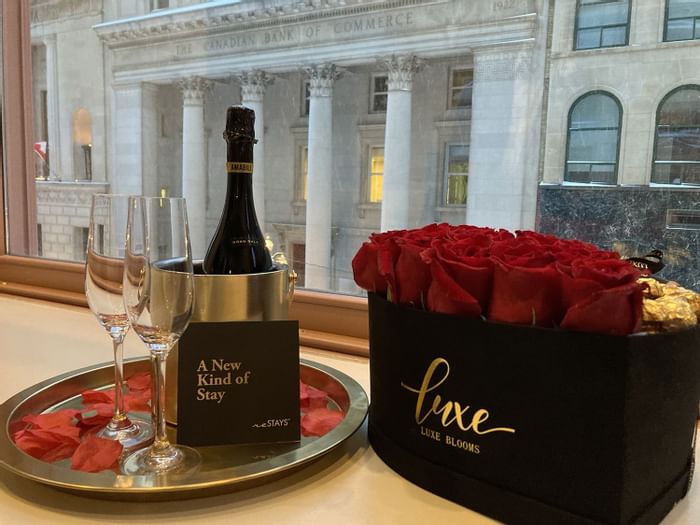 Closeup of champagne & roses by a window at ReStays Ottawa