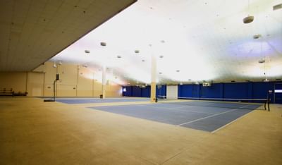 Interior of Indoor tennis court at Honor’s Haven Retreat