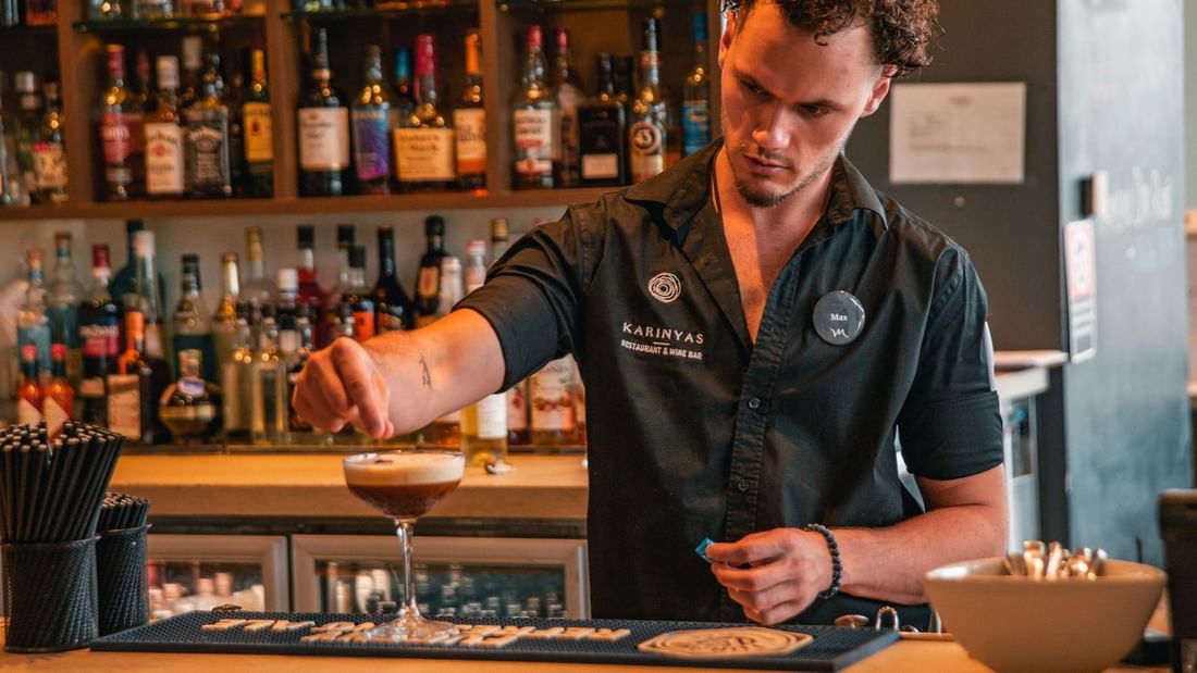 Bartender pouring a cocktail at Karinyas