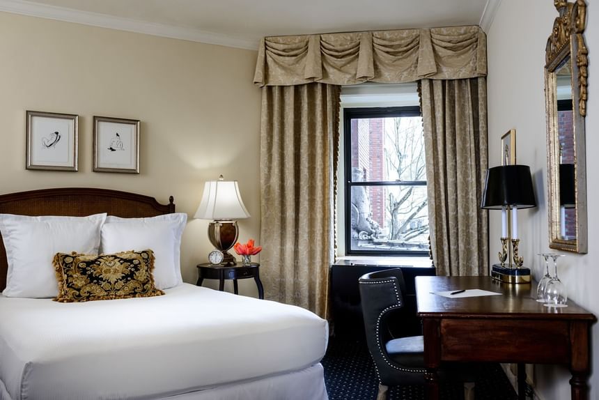 Work desk & nightstand by the bed in Classico King Room at Hotel Sorrento