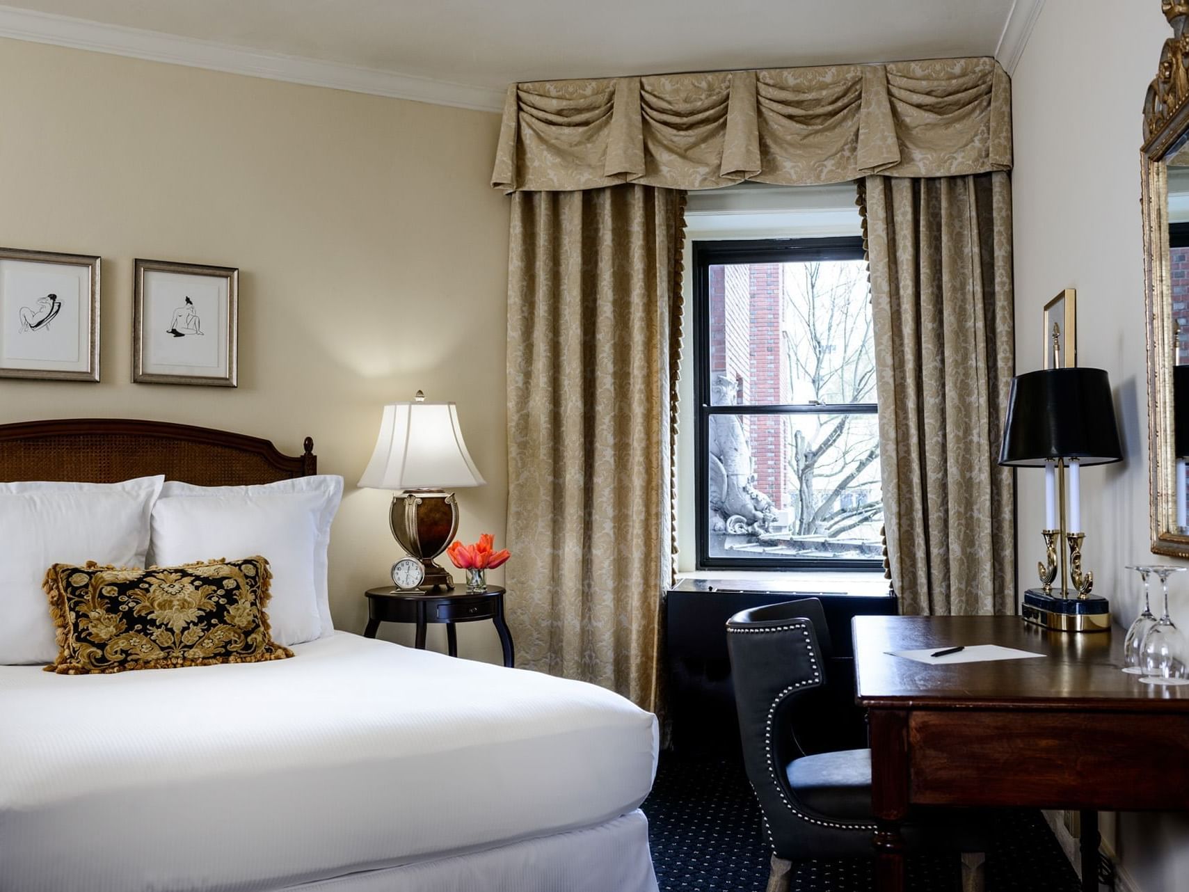 Work desk & nightstand by the bed in Classico King Room at Hotel Sorrento