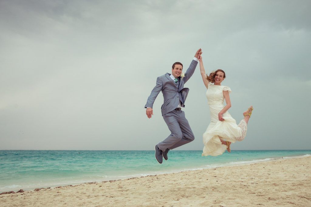 Wedding couple taking snaps by the sea near The Somerset on Grace Bay