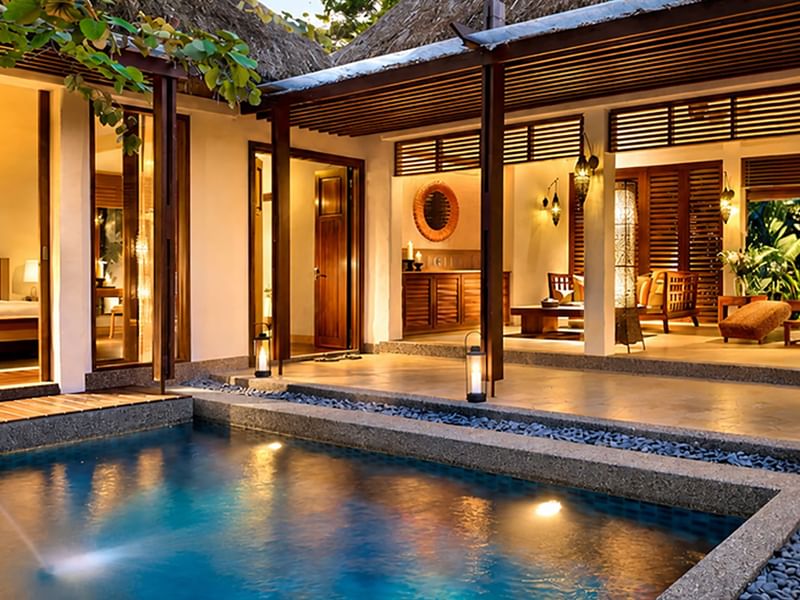 Garden pool villa with wooden louvered doors, and warm ambient lighting at dusk promoting Singaporean Residents Offer