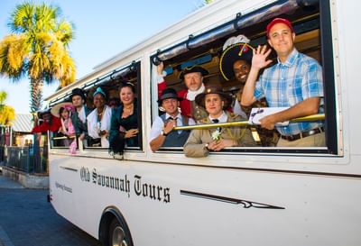 White bus with passengers for Old Savannah Tours at River Street Inn