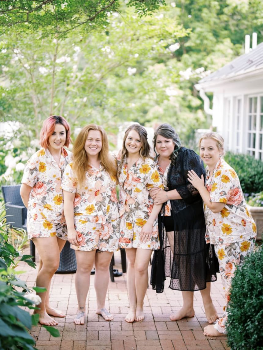 Group of girls in floral dresses posing for a group photo at The Clifton