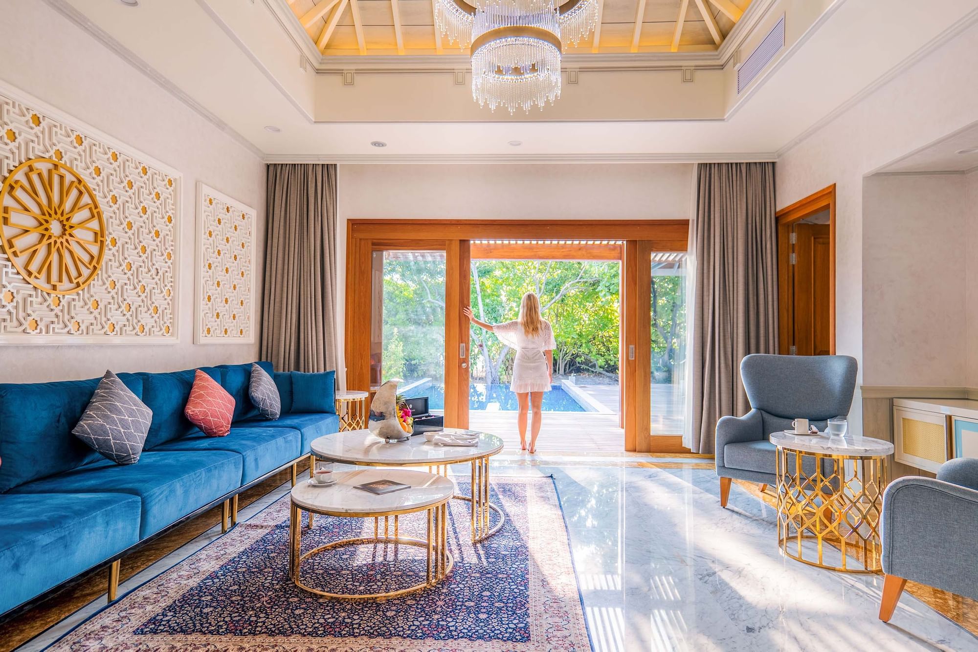 Lady standing in a living area at The Signature Collection