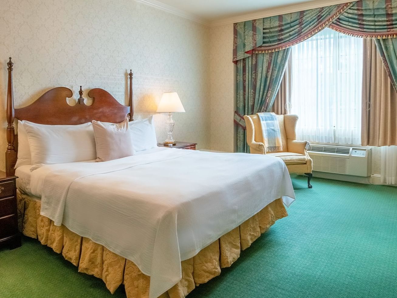 Bristol Boutique Hotel - ADA Compliant room with King bed, nightstands, cozy chair and large draped window