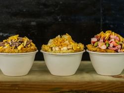 three bowls over-flowing with food