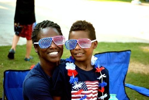 A mom and son pose together on the 4th of July, which will bring grand fireworks displays to Kissimmee, FL.