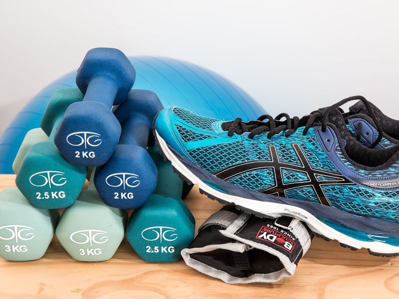 Gym shoe, dumbbells and exercise equipment