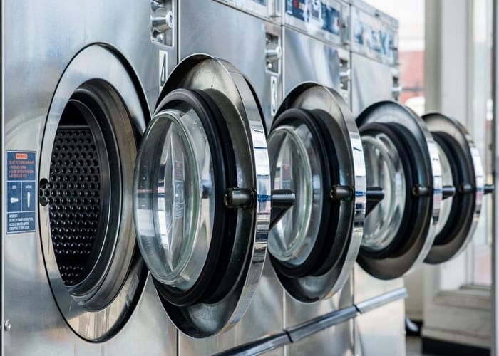 Close-up of laundry machines at Gorges Grant Hotel by Ogunquit Collection