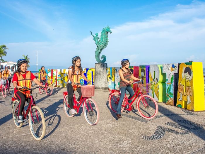 Children riding bicycles in a street by beachside at at Buenaventura Grand Hotel and Spa