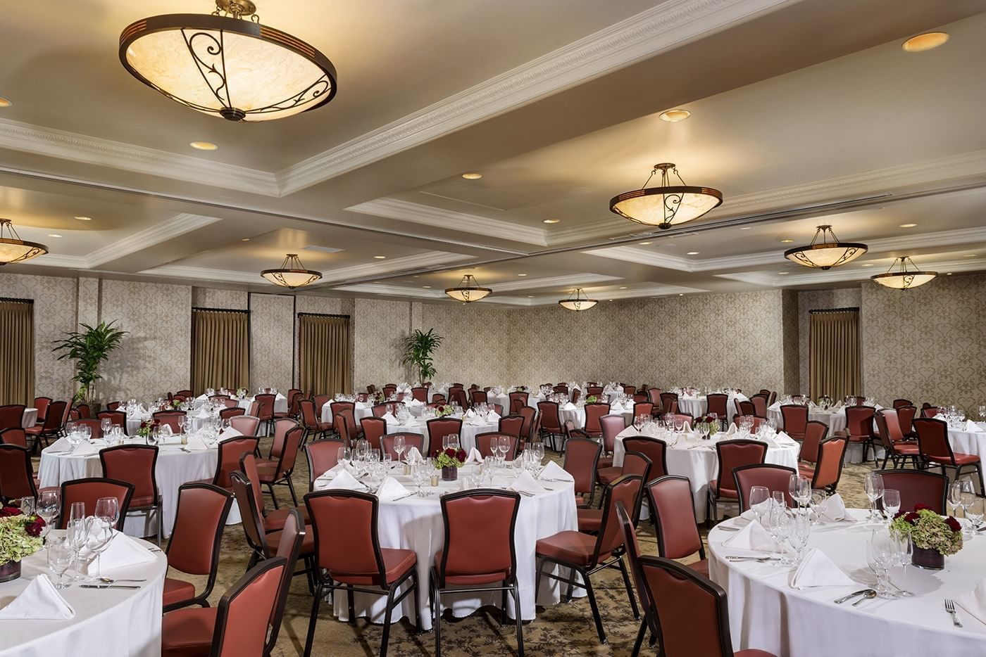 Lorem ipsum Indoor conference rooms set up with many round tables at Allegre