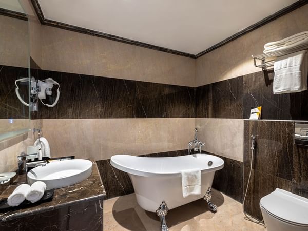 Bathroom with bathtub and vanity in Panoramic Room at Warwick Riyadh