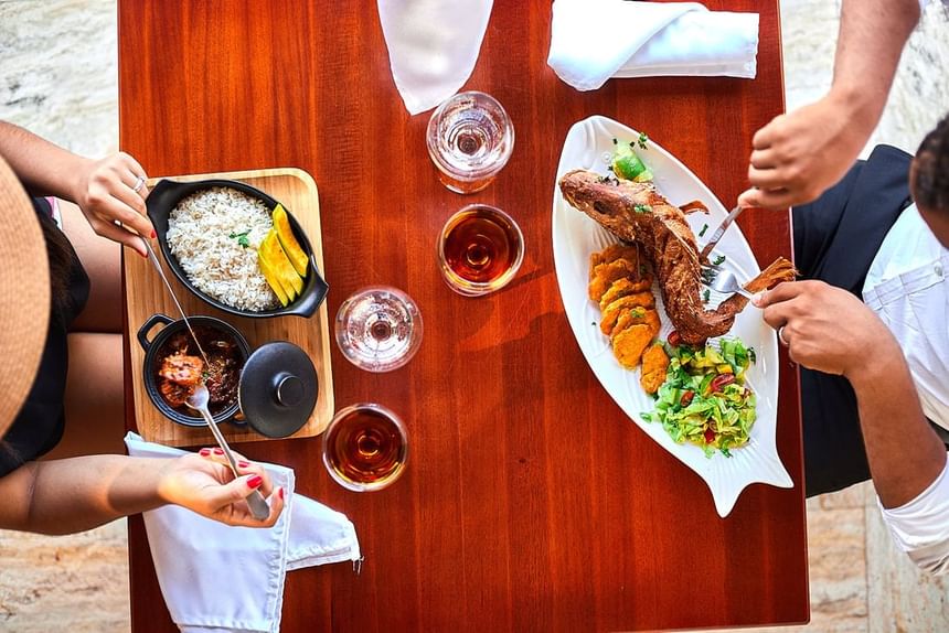 Dining table with a group of individuals enjoying a meal together at Cha Cha Hotel