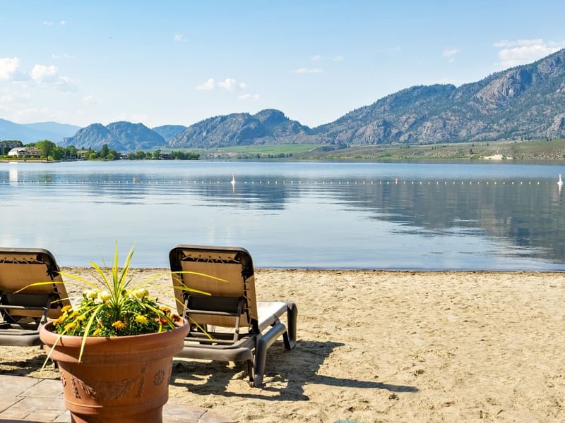 Beach chairs facing lake and mountains
