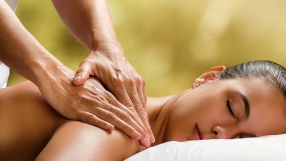 Therapist giving a shoulder massage to a guest in the spa at Oregon Garden Resort, a top choice hotel in Silverton