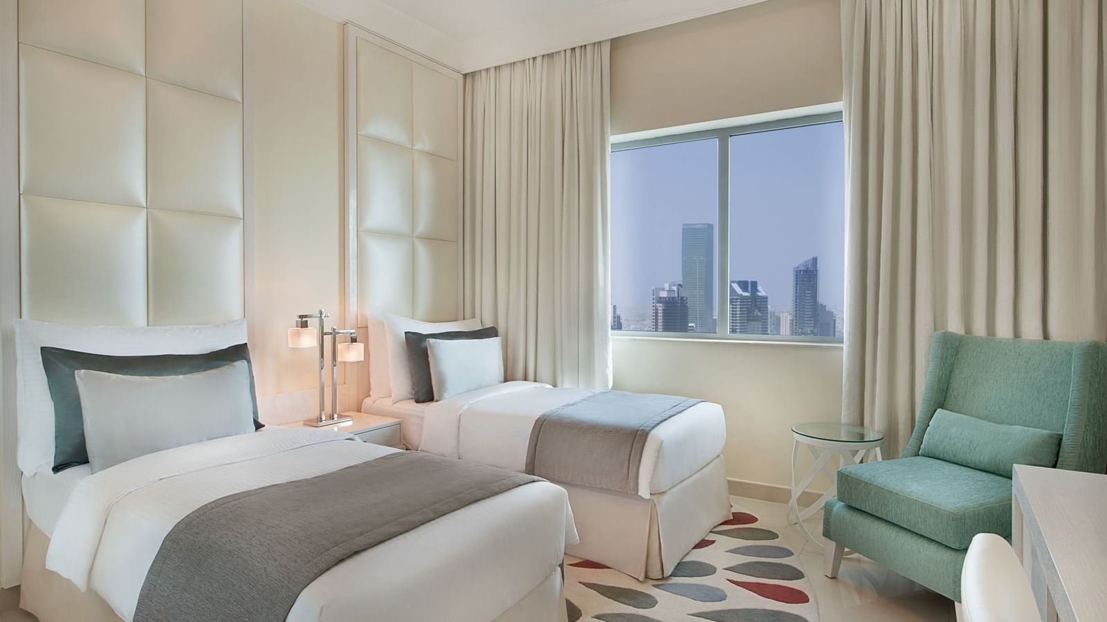 Two beds and city view in Three Bedroom Suite, one of the hotel rooms in Dubai at DAMAC Maison Mall Street