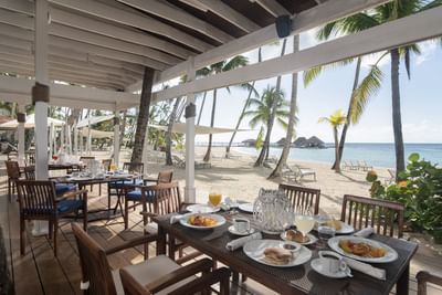 Open dining area by the beach in a restaurant at Club Hemingway