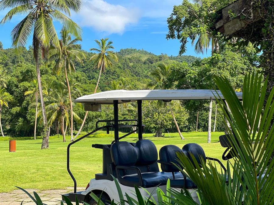 Golf cart on the course with lush greenery at The Naviti Resort in Korolevu, Fiji