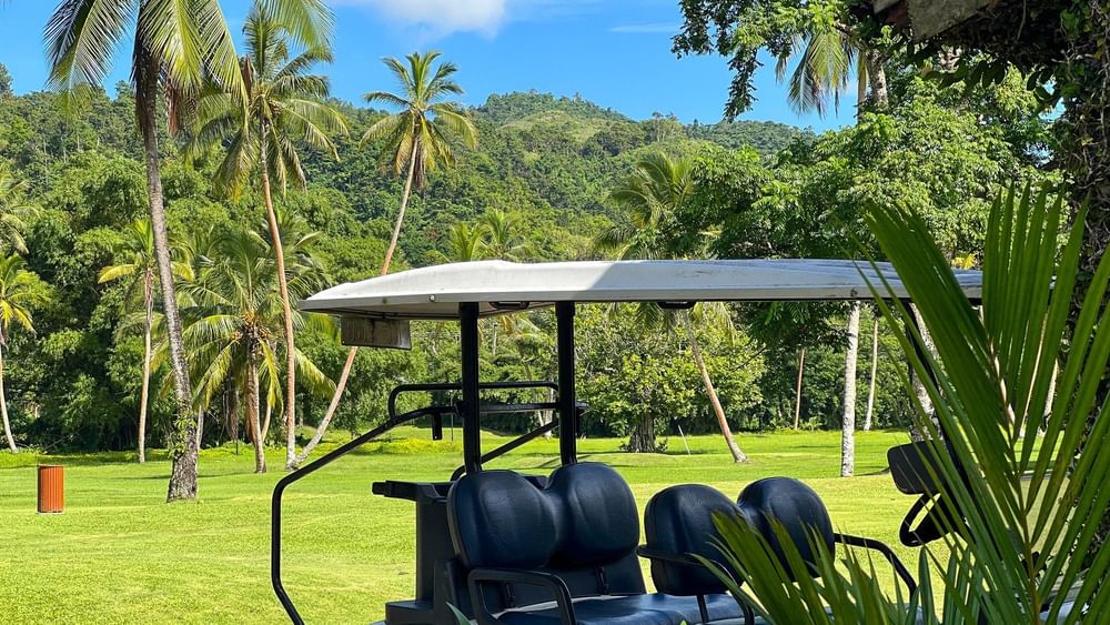 Golf cart on the course with lush greenery at The Naviti Resort in Korolevu, Fiji.