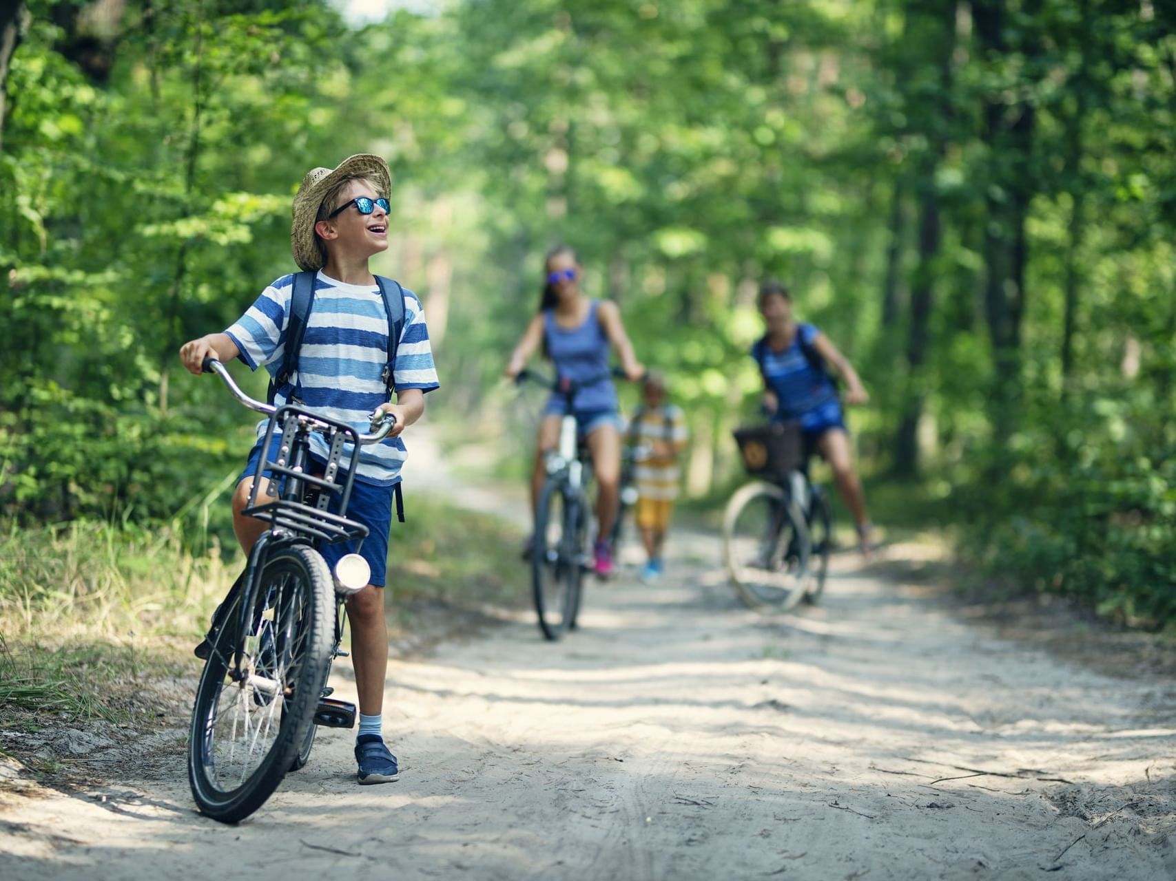 Child on a bicycle in the forest near Chase on The Lake