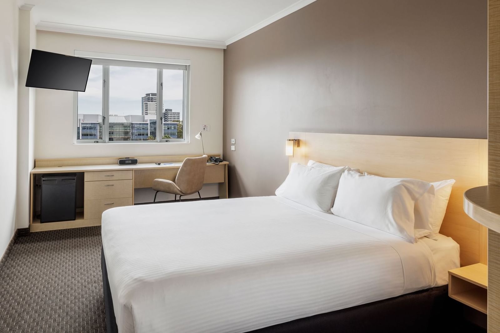 Standard Room with a calm ambiance, featuring a comfy Queen bed, work desk, TV & a window at Novotel Sydney Olympic Park