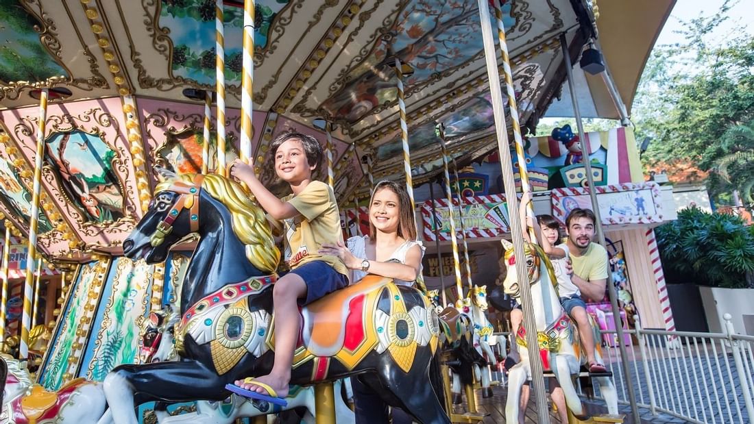 A family enjoying carousal at Amusement Park near Sunway Lagoon