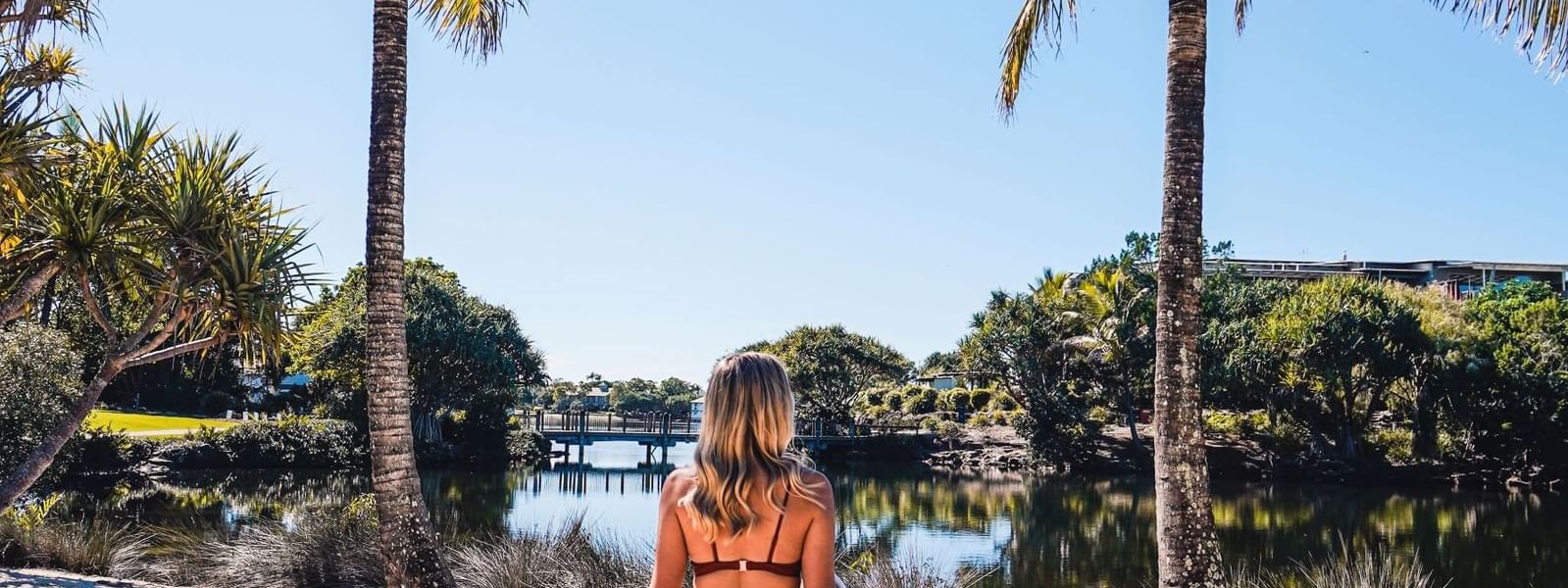Lady overlooking the scenic view of the lake, featuring Vitamin D Package at Novotel Sunshine Coast Resort