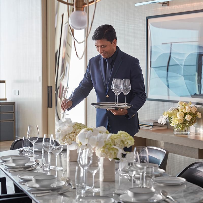 A waiter arranging a table at Crown Towers Sydney