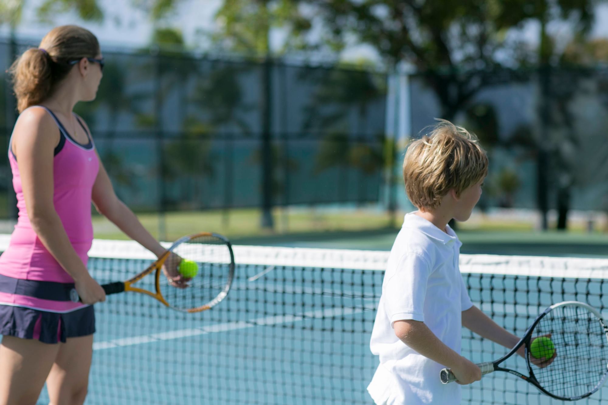 Mom & son playing tennis