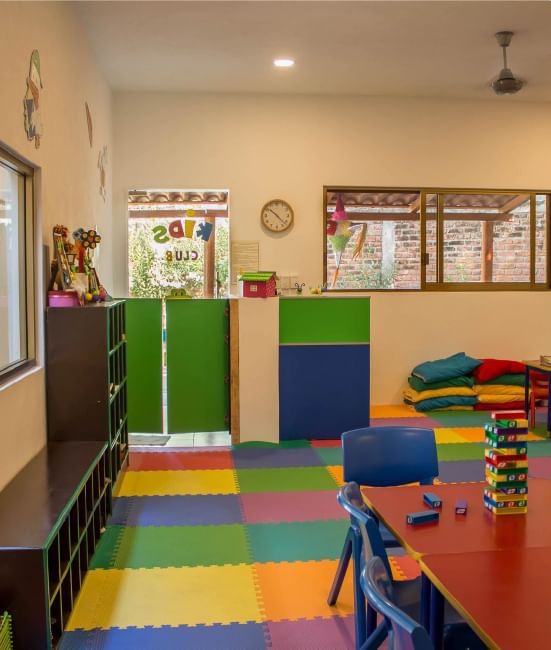 A playroom with toys, foam mats & Jenga blocks on a table at Plaza Pelicanos Club Beach Resort