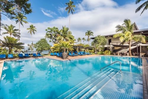 Relaxing sunbeds by the outdoor swimming pool near Warwick Fiji