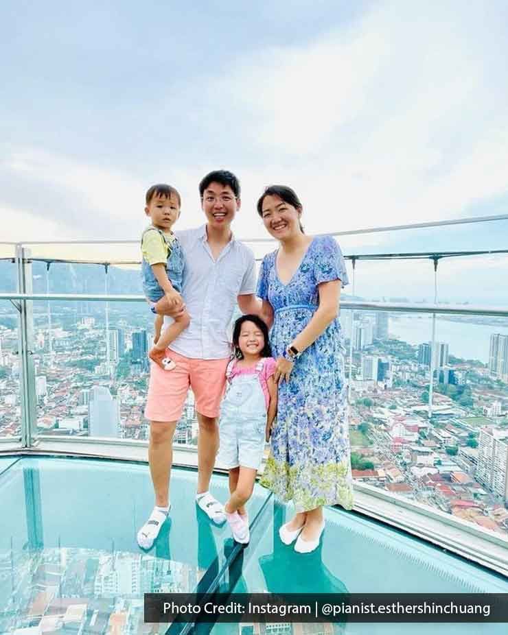 A family was taking a photo at The TOP Penang Rainbow Skywalk - Lexis Suites Penang