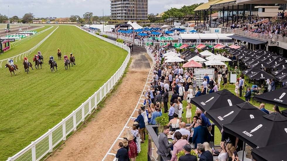 Crowded racecourse with horses on the track at Brisbane Racing Club near Sofitel Brisbane Central