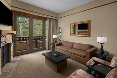 TV lounge with fireplace by the window in Executive Suite at Hotel Park City Autograph Collection