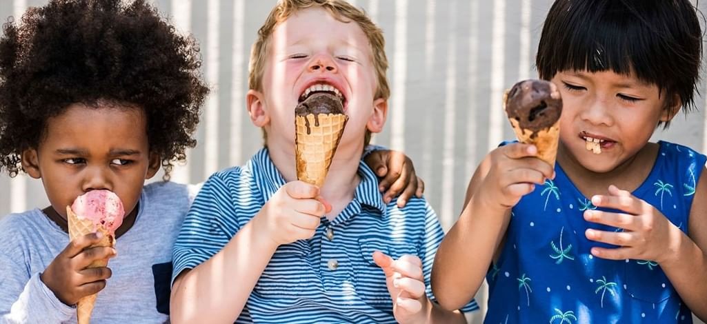 three kids eating ice cream cones