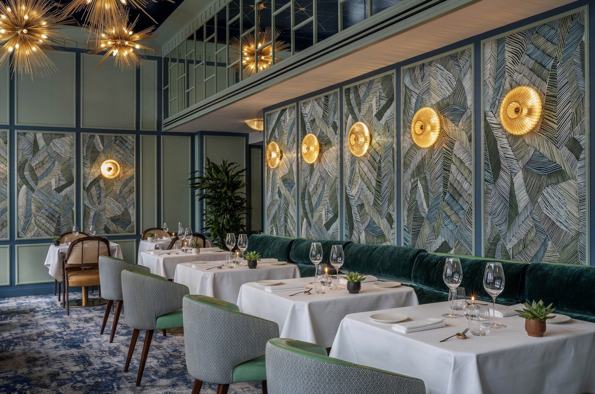 Dining area with tables, velvet bench under wall lights at The Capital Hotel, Apartments and Townhouse