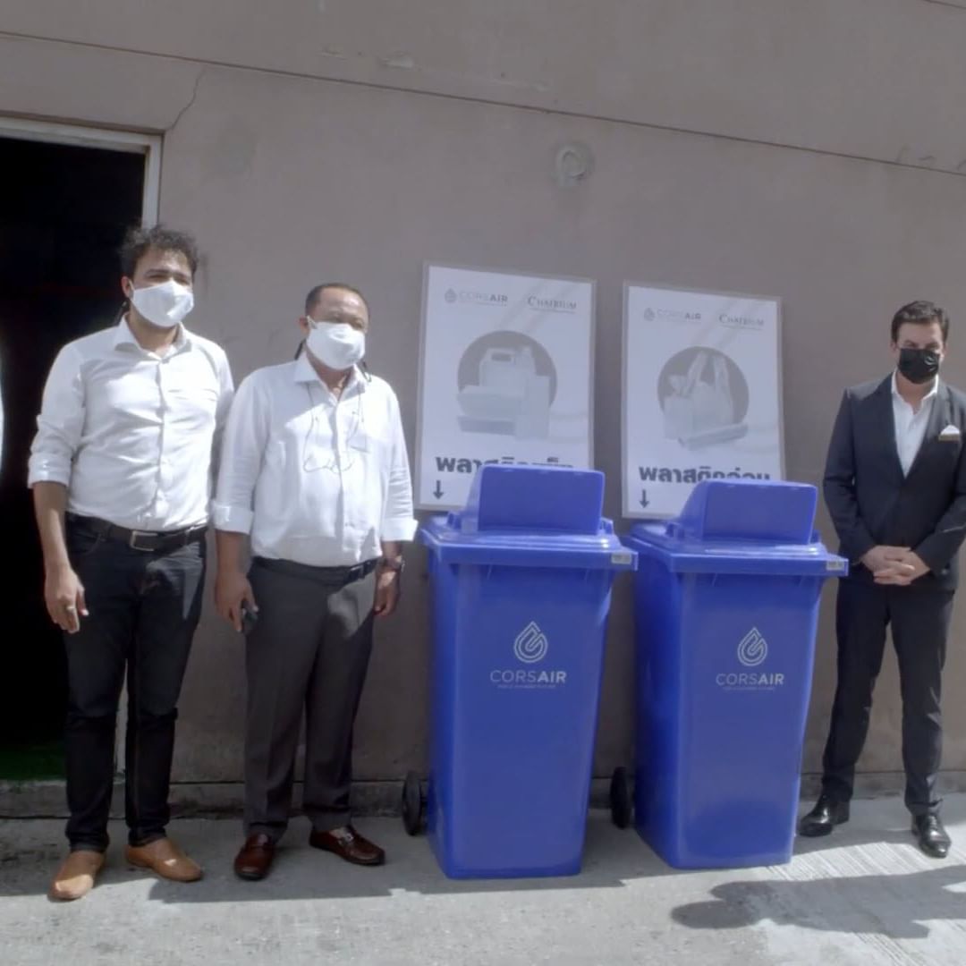 People standing by recycling bins, Emporium Suites by Chatrium
