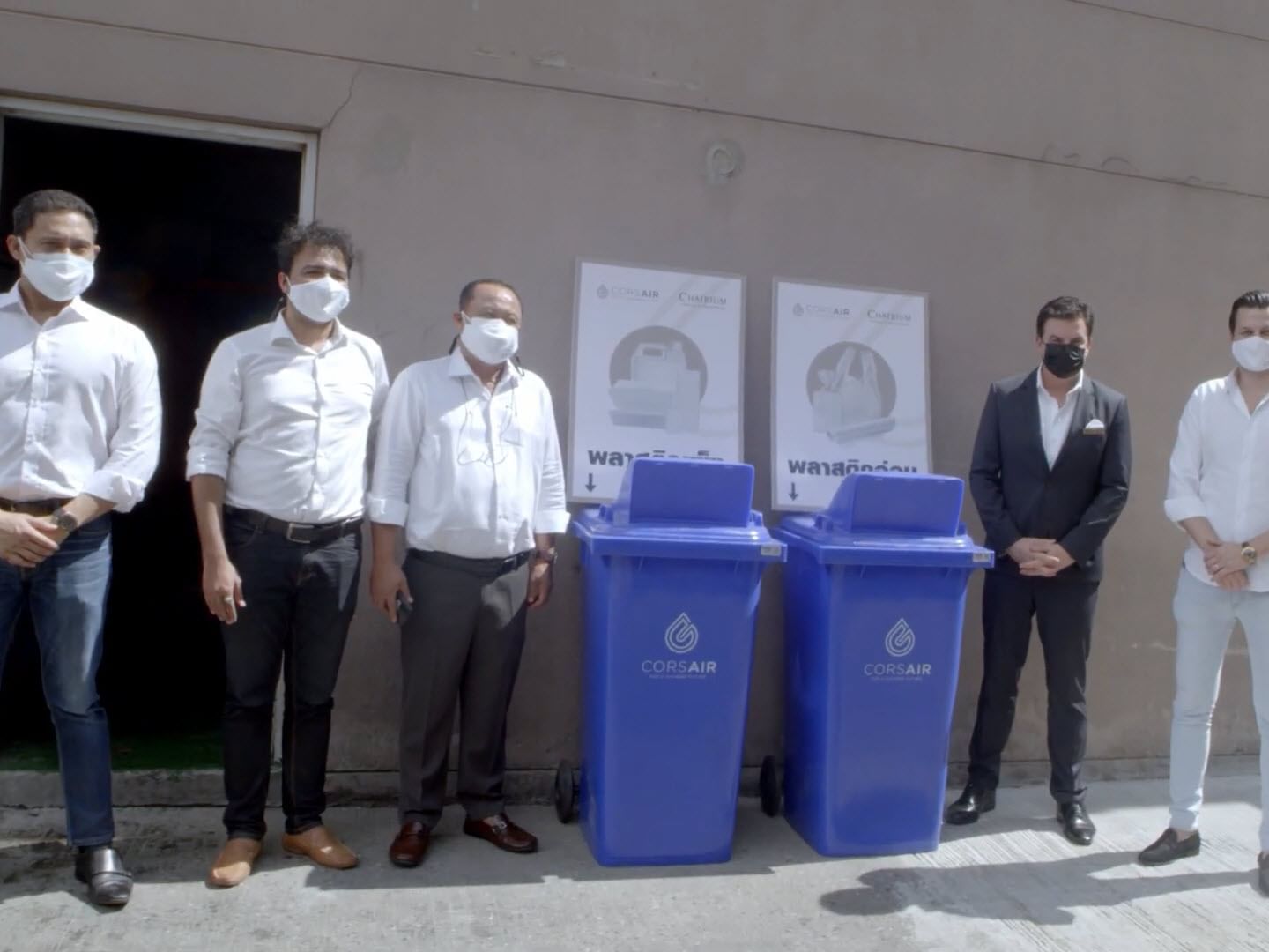 People standing by recycling bins, Emporium Suites by Chatrium