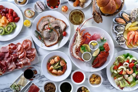 Elegant table setting with gourmet seafood, meats, and fruits served in Opera at Park Hyatt Saigon