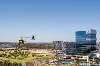Aerial shot of Helicopter flying in front of Crown Hotels Perth