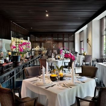 Senja dining area at The Saujana Hotel Kuala Lumpur with wedding decor, wine glasses, and a wooden ceiling