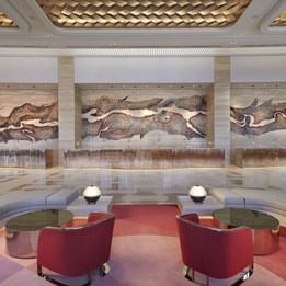 Sitting area with wall art in the lobby at Crown Towers Perth