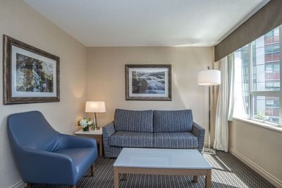 Seating area with couch and chair in hotel